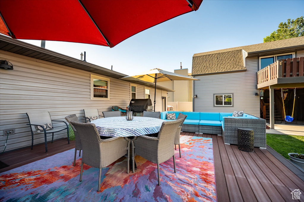 Wooden terrace featuring an outdoor living space and outdoor dining area