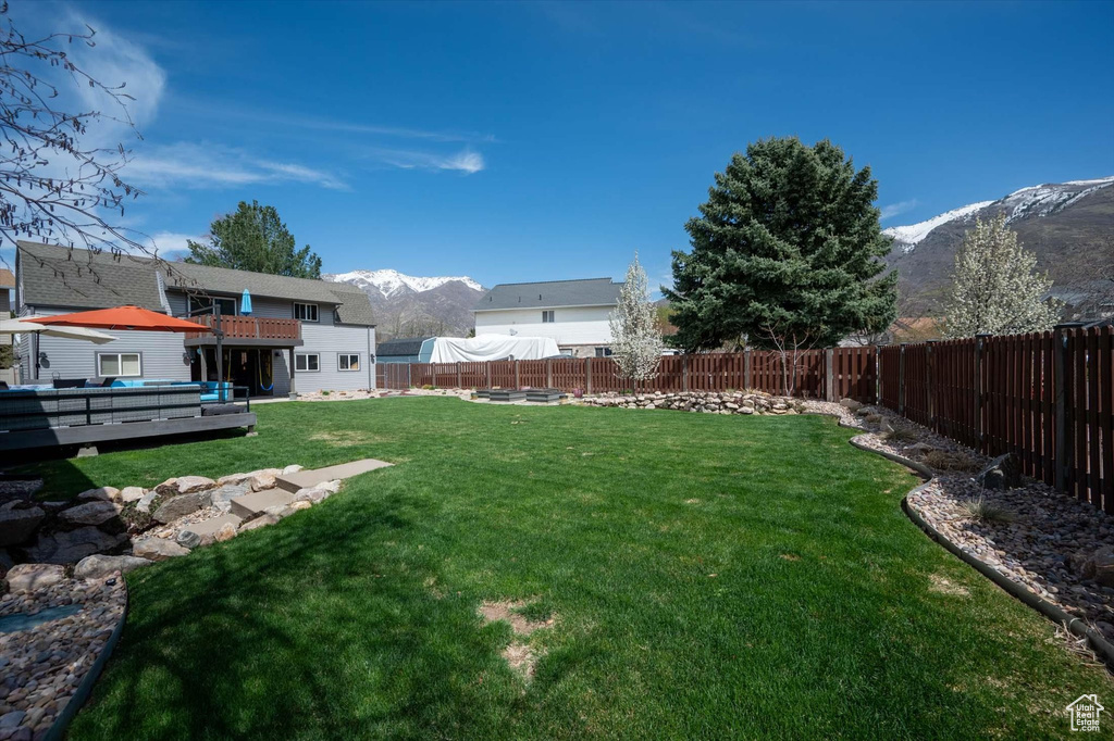 View of yard featuring a deck with mountain view