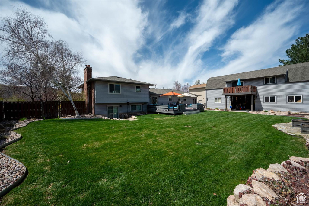 View of yard with a deck and an outdoor living space