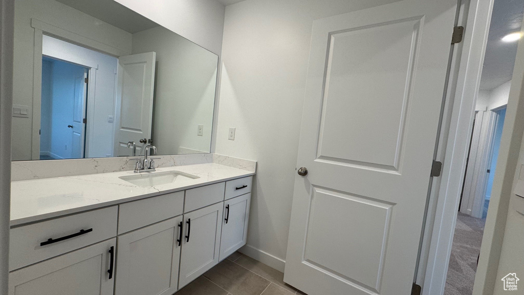 Bathroom featuring vanity and baseboards