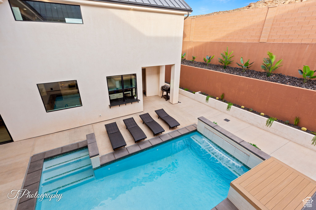 View of pool featuring a fenced backyard and a patio area