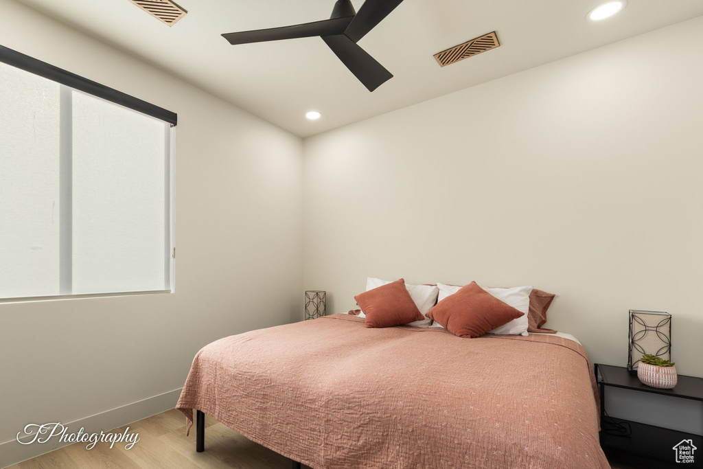Bedroom featuring wood finished floors, baseboards, recessed lighting, and ceiling fan