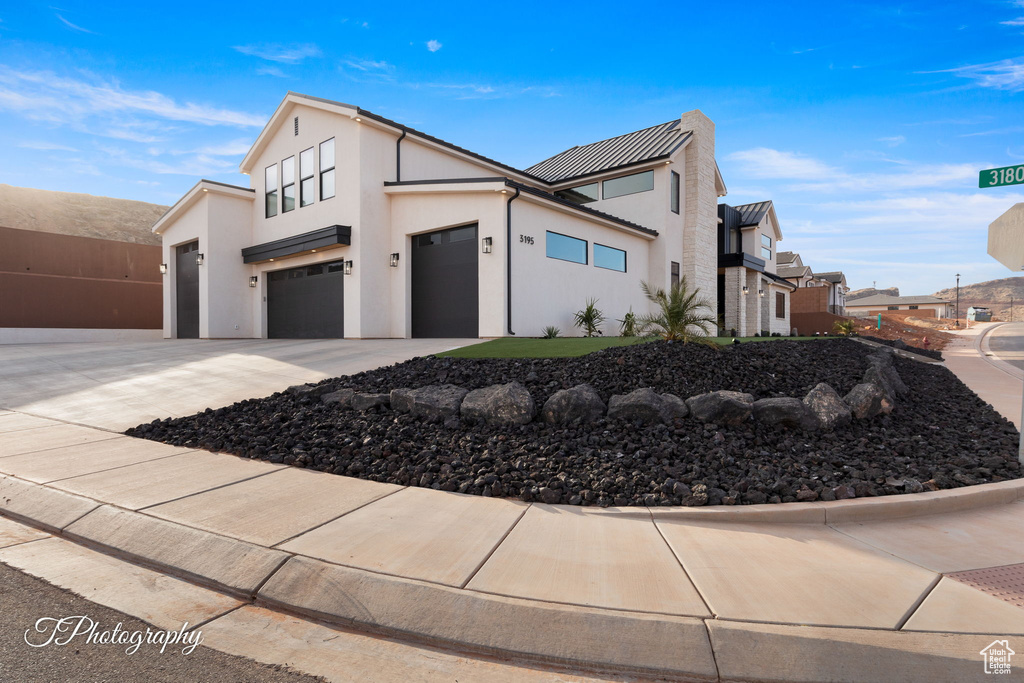 View of property exterior featuring stucco siding, driveway, and a garage