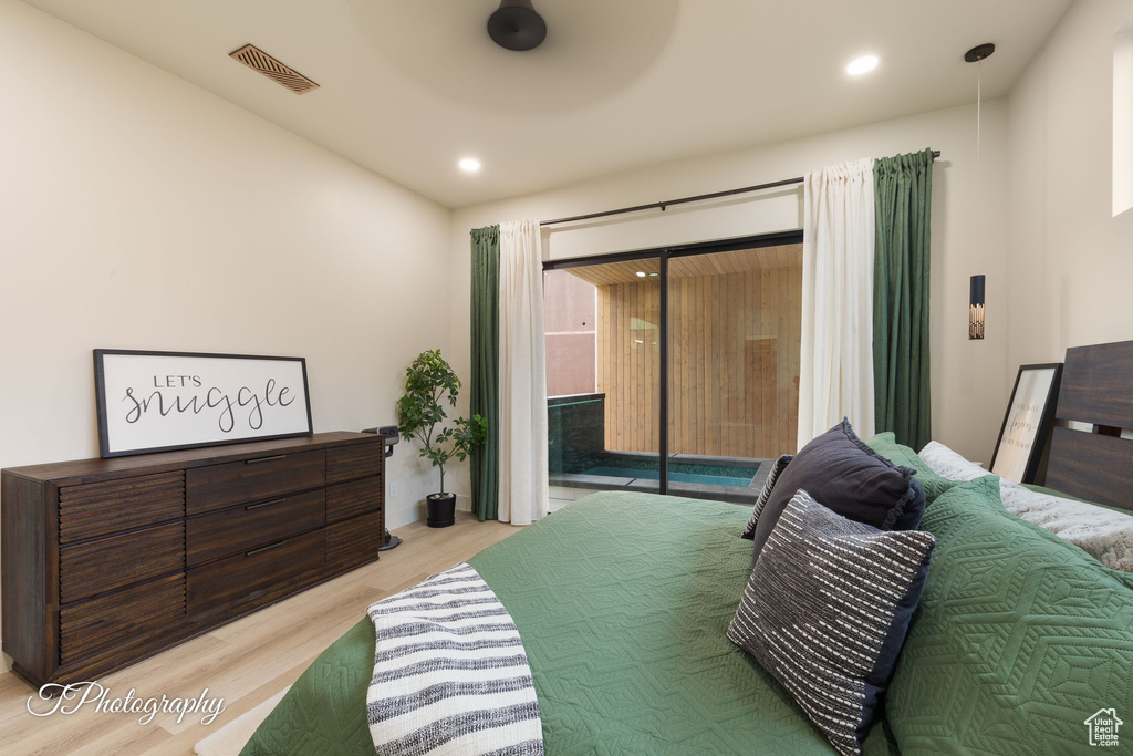 Bedroom with light wood-type flooring, access to outside, and recessed lighting