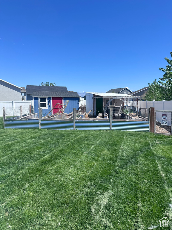 Rear view of property featuring an outdoor structure and a storage shed