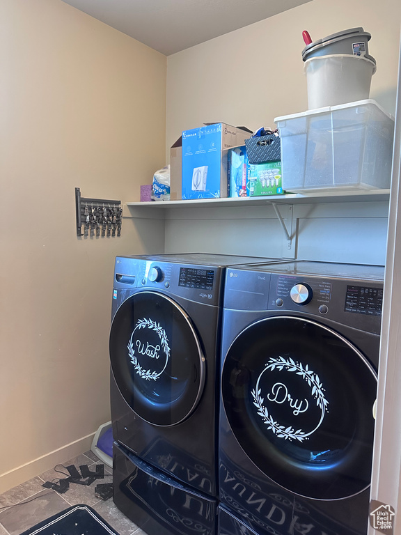 Laundry room featuring washing machine and clothes dryer and baseboards