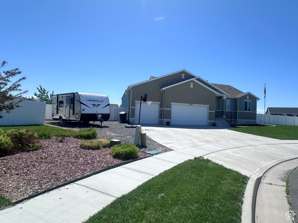 View of front of home featuring driveway and a garage