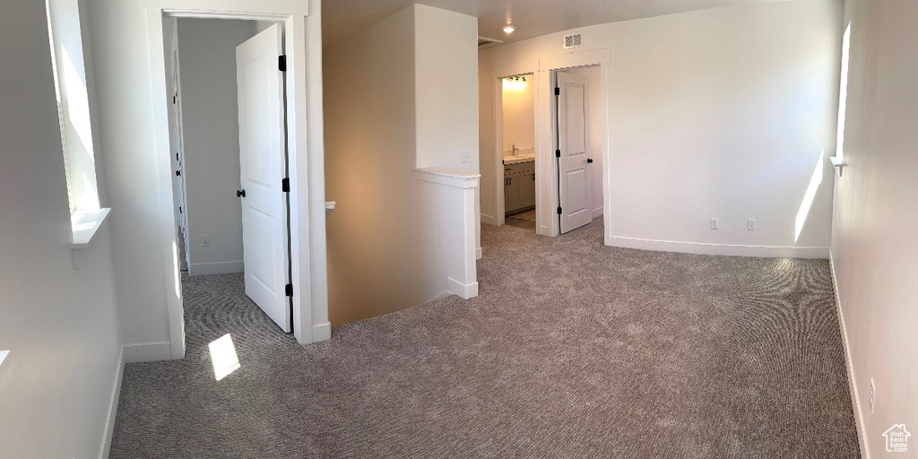 Unfurnished bedroom with carpet flooring