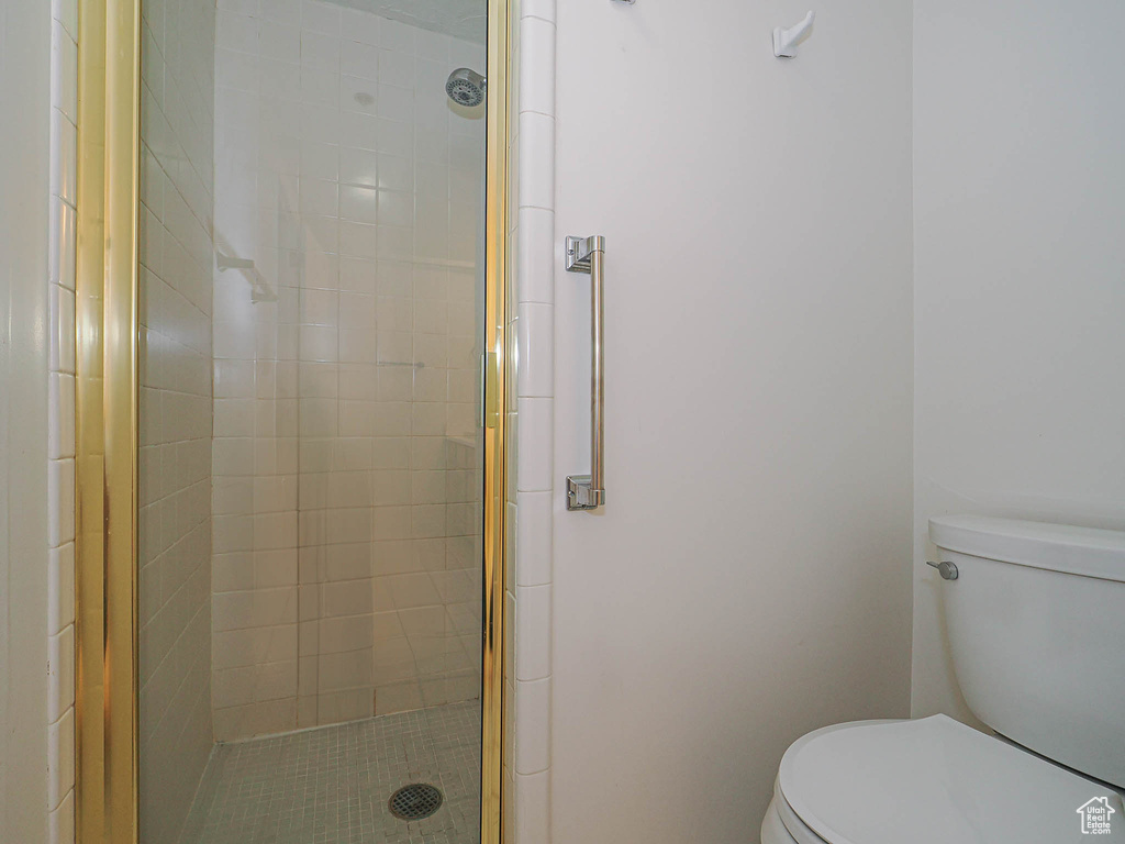Bathroom with toilet and a stall shower