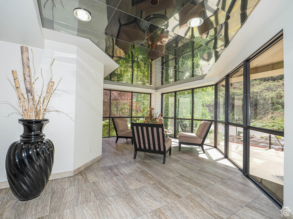 Sunroom / solarium with a towering ceiling