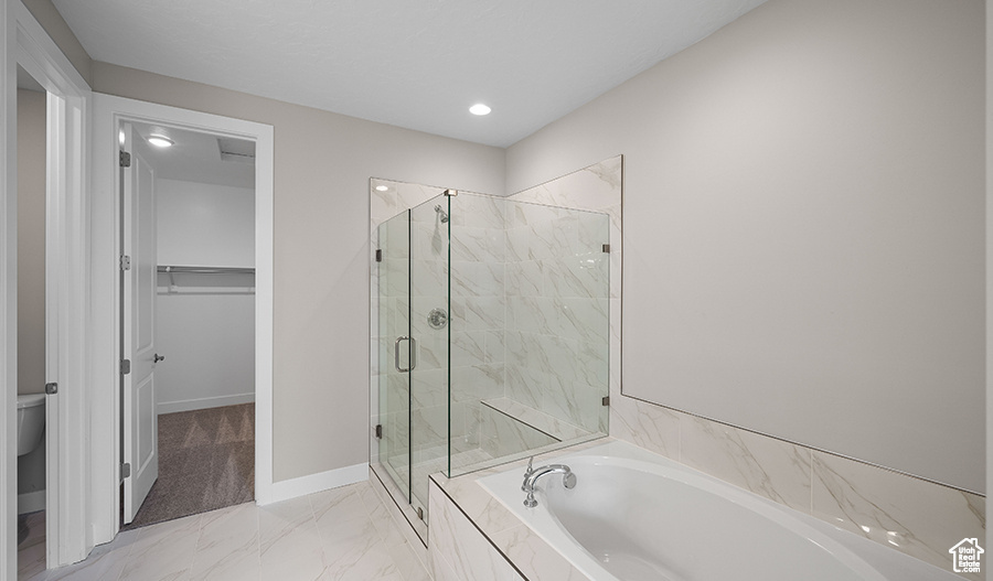 Full bath with a garden tub, a marble finish shower, recessed lighting, a spacious closet, and toilet