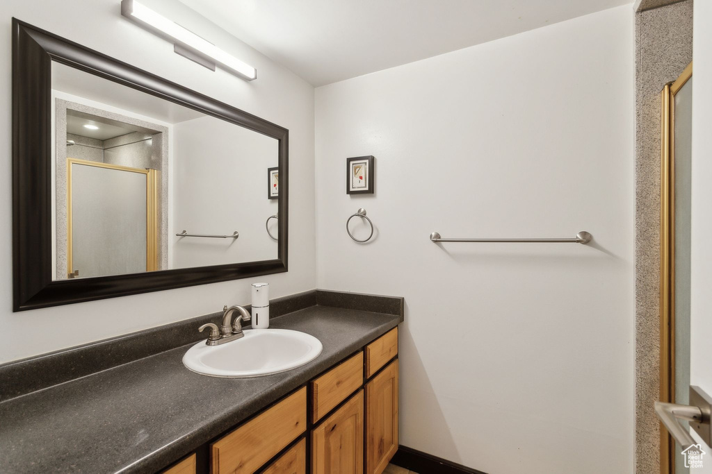 Bathroom with a shower stall and vanity