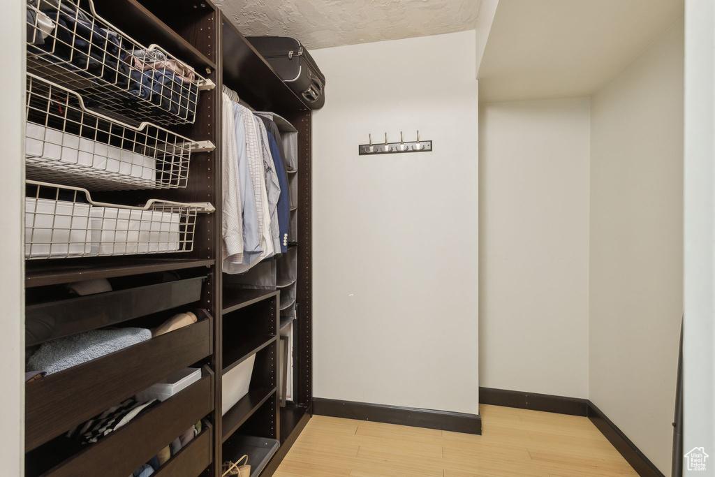 Spacious closet with wood finished floors