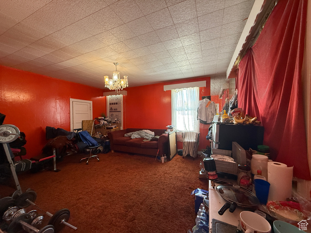 Misc room with carpet flooring, a chandelier, and radiator