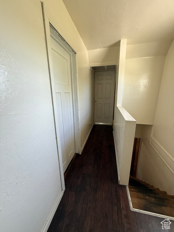 Hallway with wood finished floors and baseboards