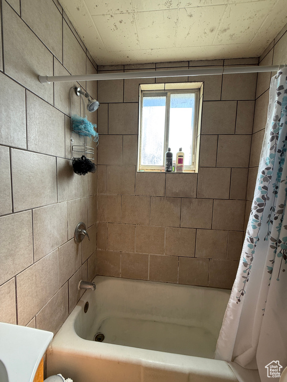 Full bath featuring shower / tub combo with curtain and vanity