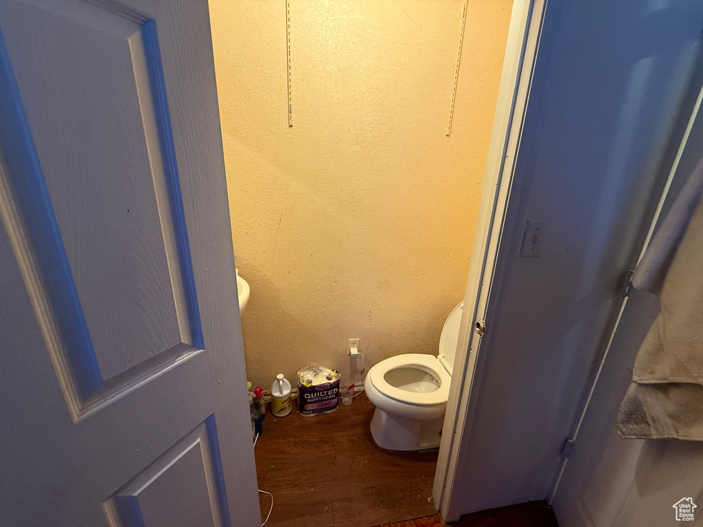 Bathroom with wood finished floors and toilet