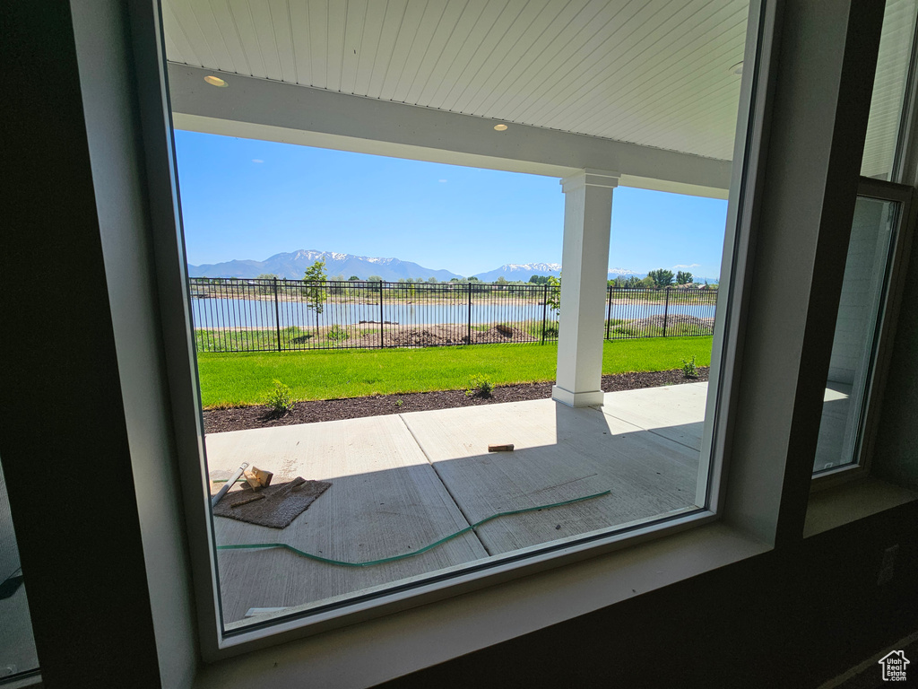 Entryway with a water and mountain view