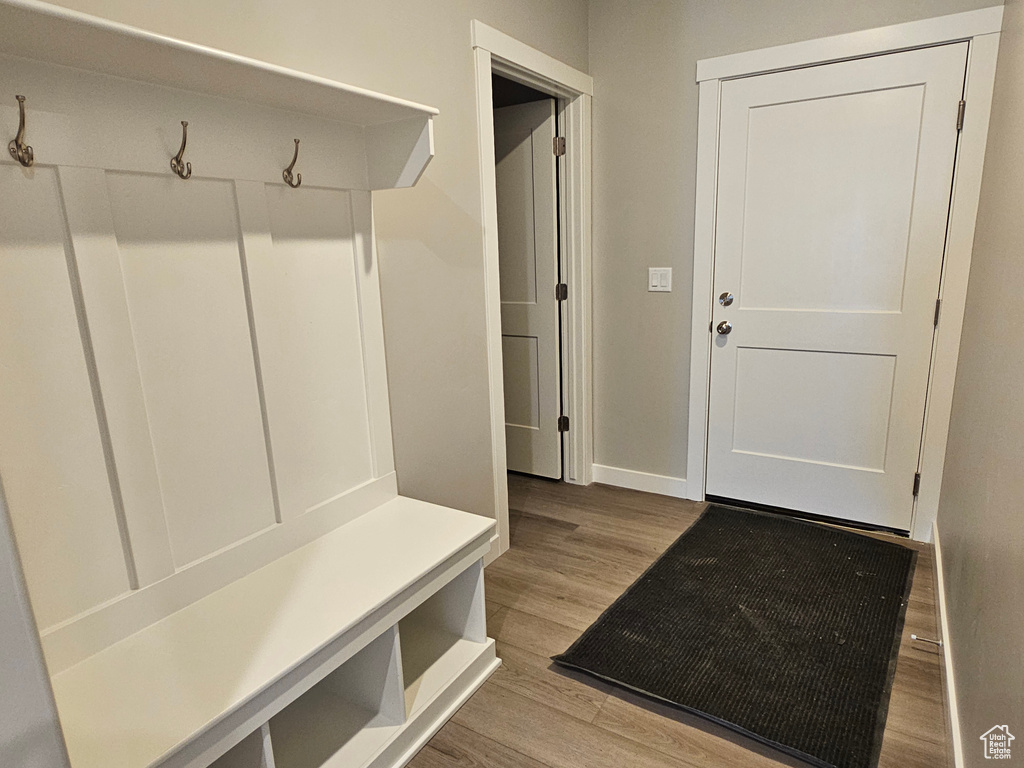Mudroom with wood finished floors and baseboards
