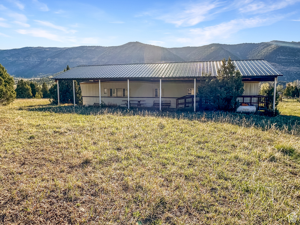 View of property exterior with a mountain view and metal roof