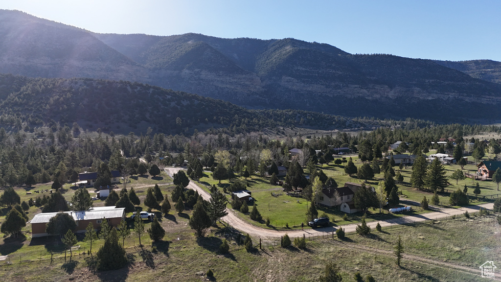 Aerial view of property and surrounding area with a mountainous background