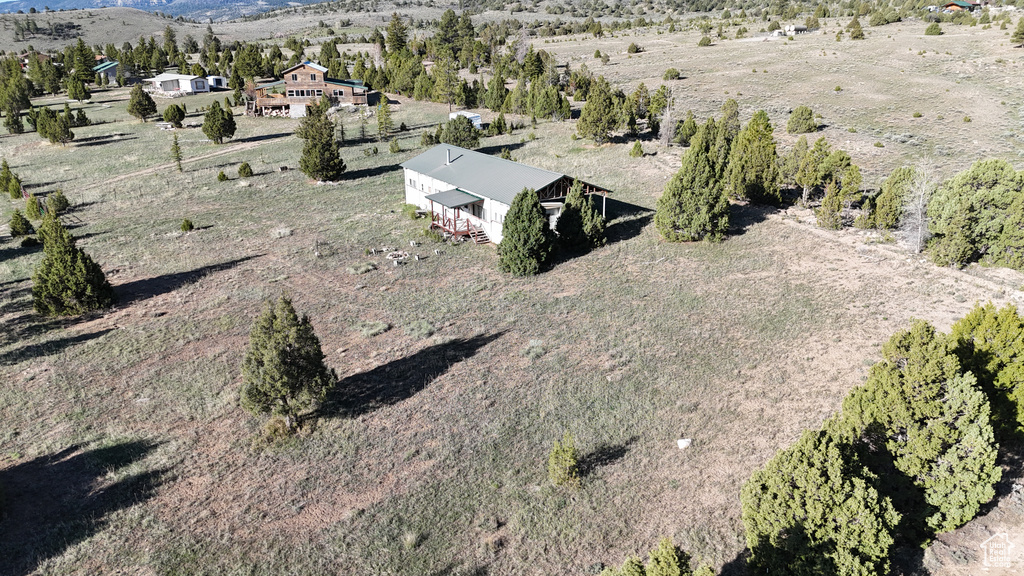 Aerial view of property and surrounding area with a mountainous background