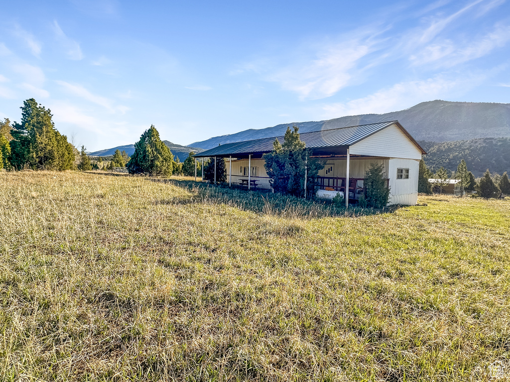 Rear view of property with a mountain view