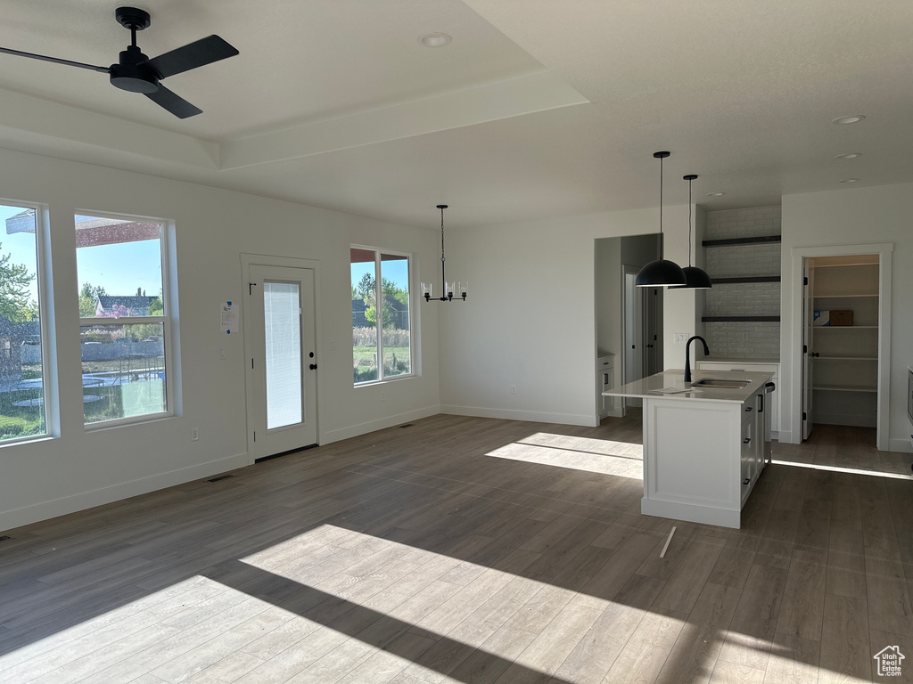 Kitchen with a sink, ceiling fan, healthy amount of natural light, dark wood finished floors, and recessed lighting