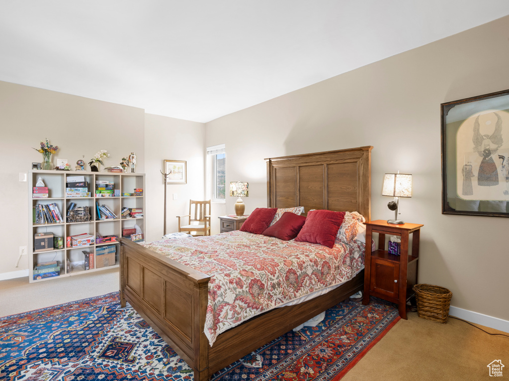 Bedroom featuring carpet floors and baseboards