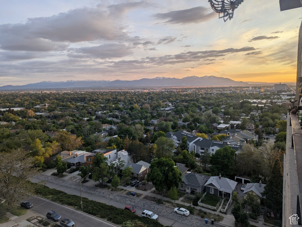 Aerial view of property and surrounding area featuring a mountain backdrop