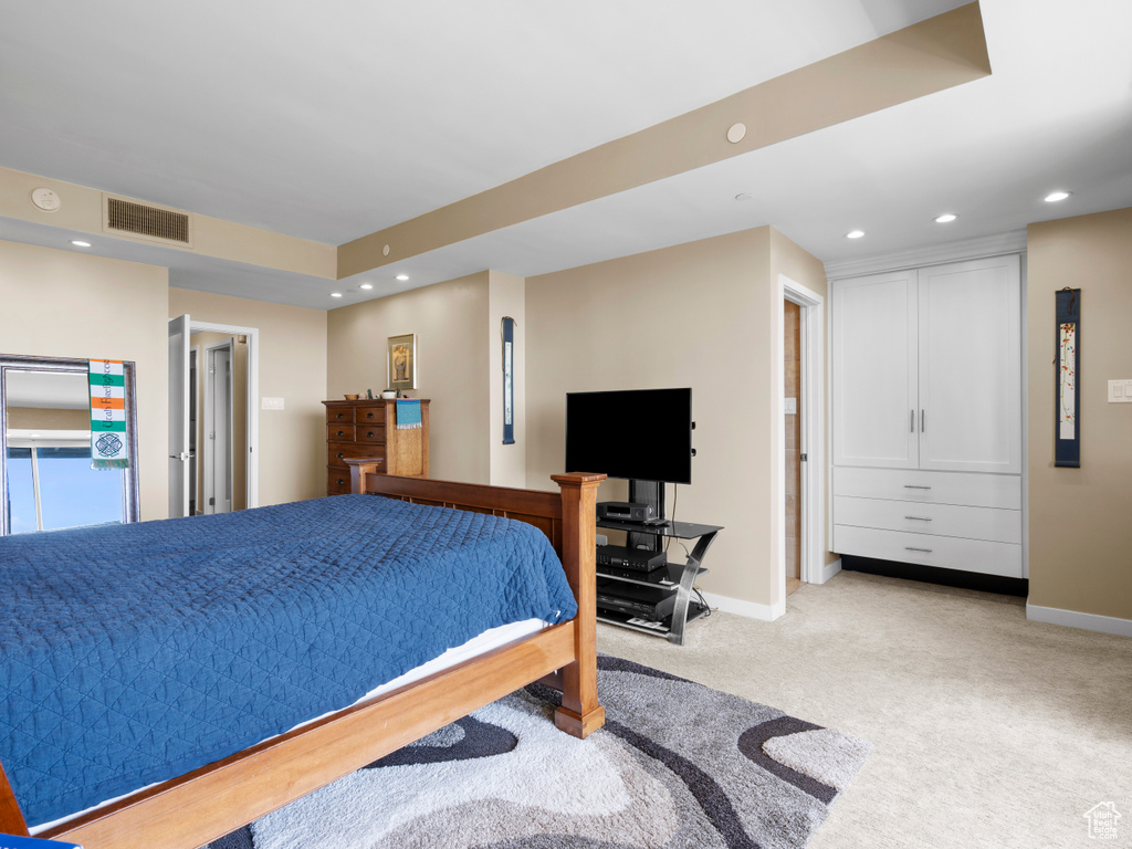 Bedroom featuring light colored carpet, baseboards, and recessed lighting
