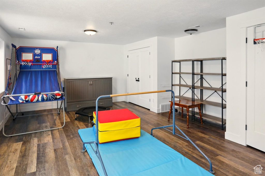 Recreation room featuring wood finished floors and baseboards