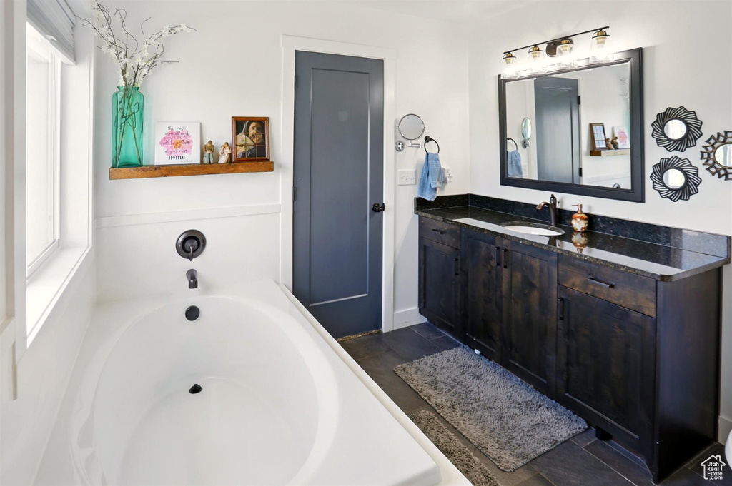 Full bath with a garden tub and vanity