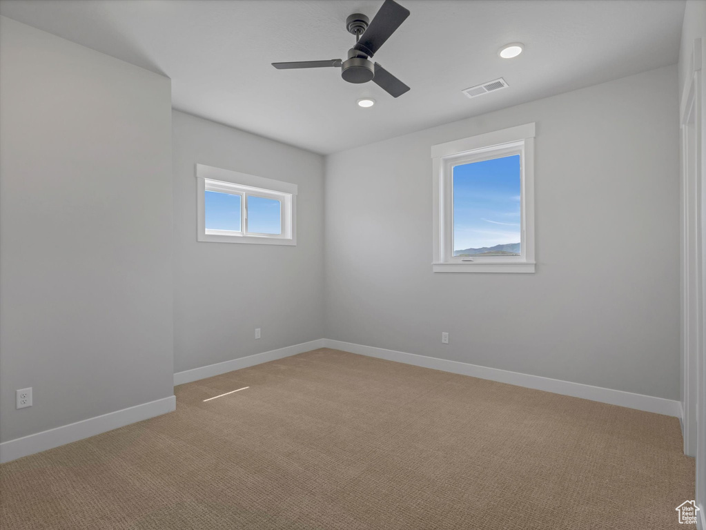 Unfurnished room featuring a ceiling fan, light carpet, baseboards, and recessed lighting