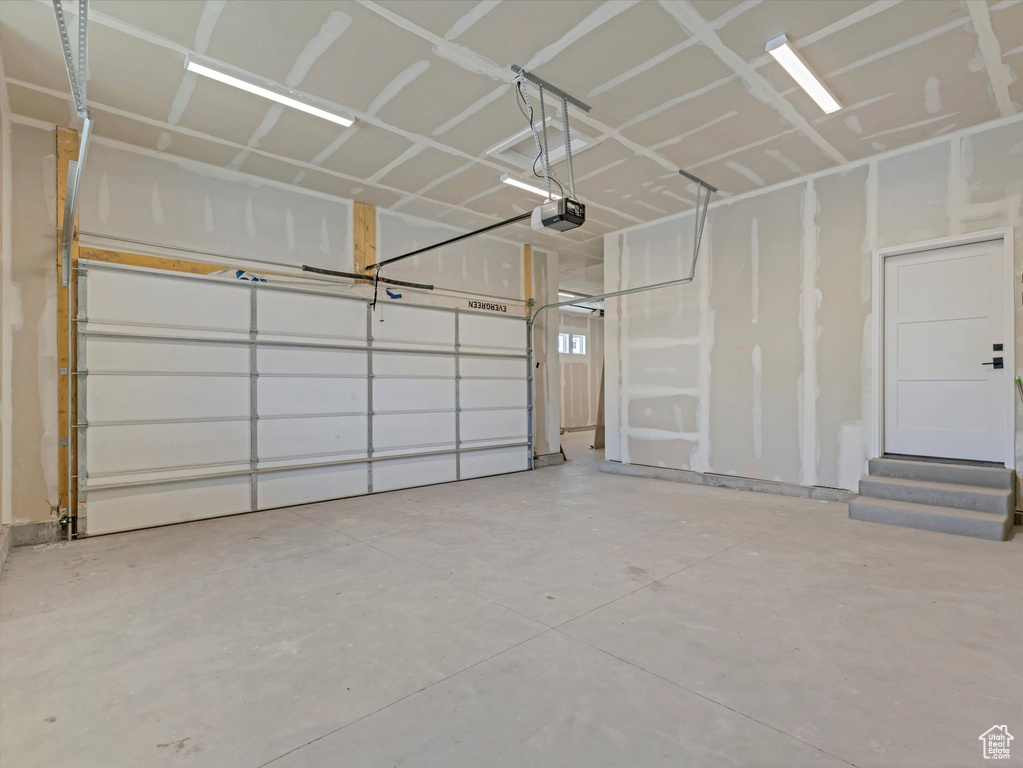 Garage featuring a garage door opener