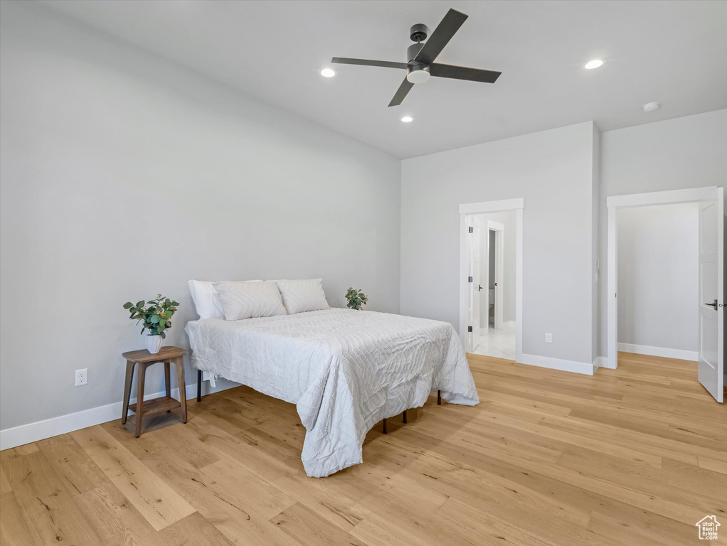 Bedroom with light wood-type flooring, baseboards, recessed lighting, and a ceiling fan