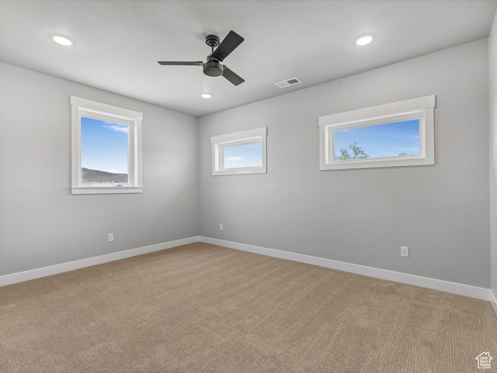 Unfurnished room featuring a ceiling fan, light colored carpet, baseboards, and recessed lighting