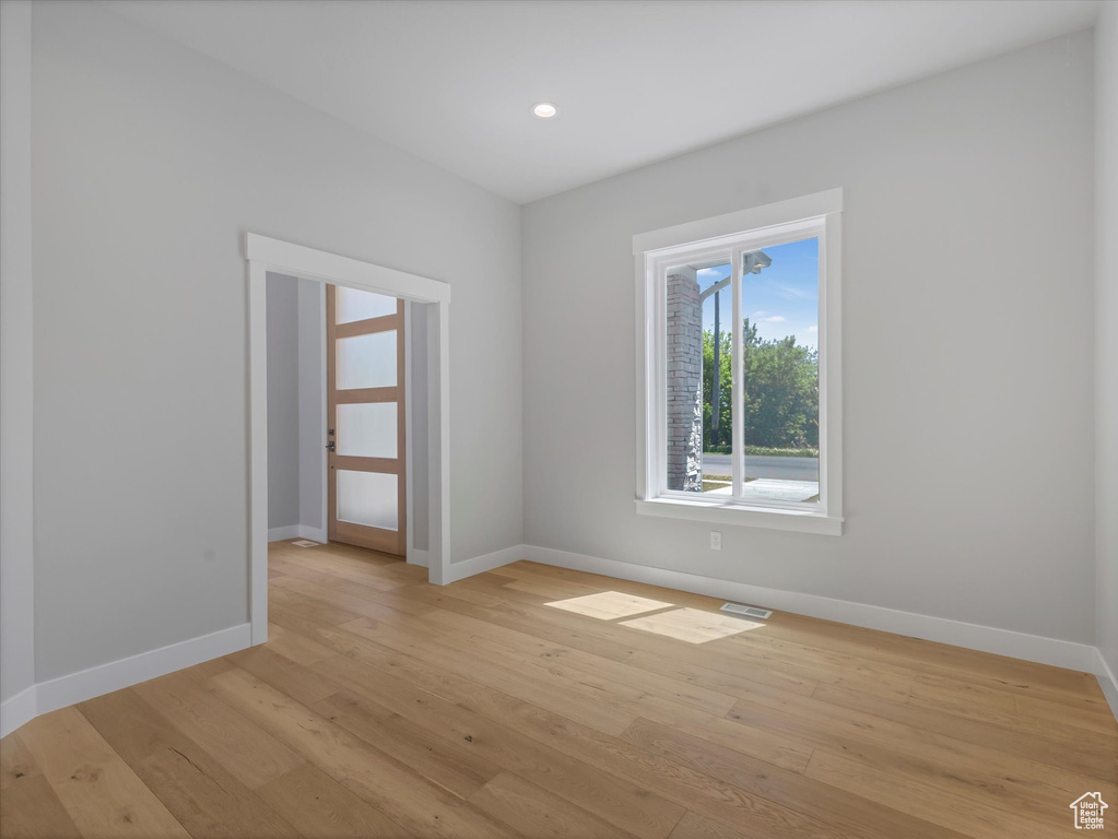 Unfurnished room with light wood-type flooring, baseboards, and recessed lighting