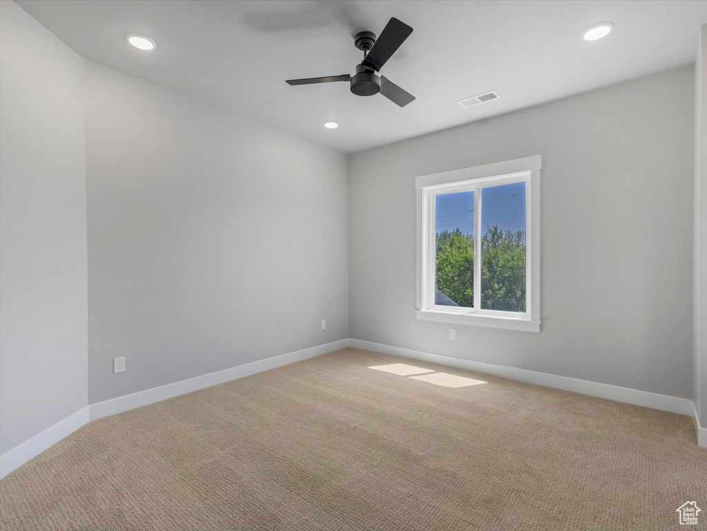 Carpeted spare room with baseboards, ceiling fan, and recessed lighting