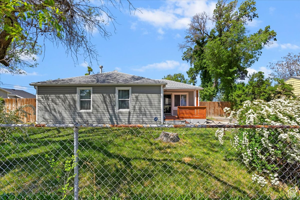 Back of property with a wooden deck