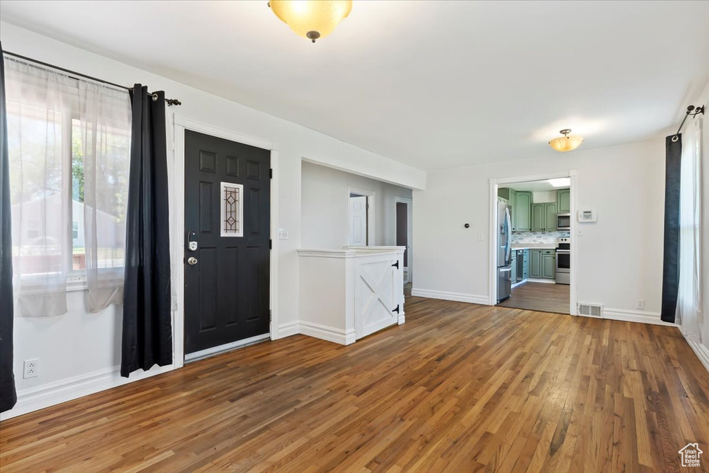 Entrance foyer with wood finished floors and baseboards