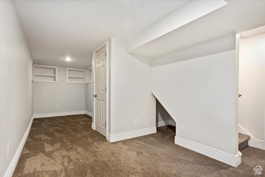 Basement with carpet floors, baseboards, recessed lighting, and stairway