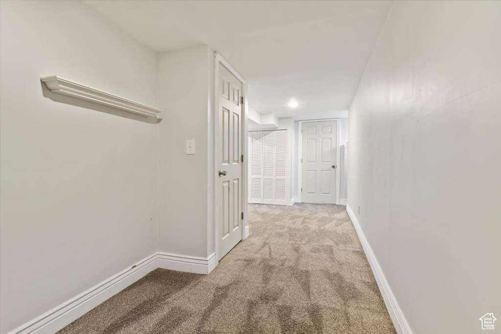 Hall with carpet floors and baseboards