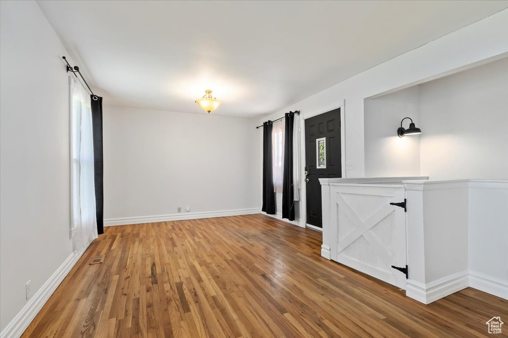 Spare room featuring wood finished floors and baseboards