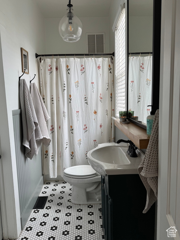 Full bathroom featuring toilet and vanity
