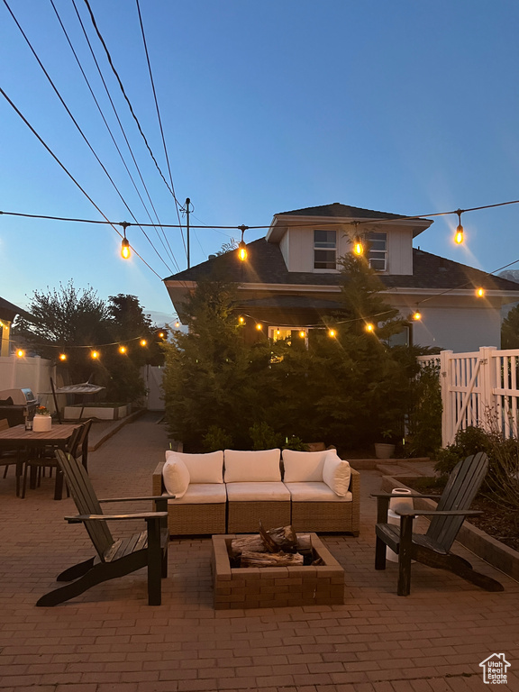 View of patio featuring an outdoor living space and fence