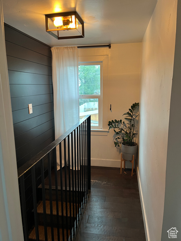 Stairway with wood-type flooring and baseboards