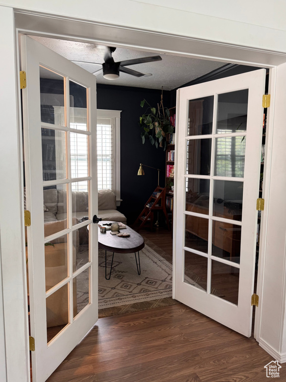 Doorway with french doors and wood finished floors