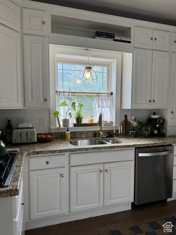 Kitchen featuring dishwasher, a sink, white cabinetry, and gas cooktop