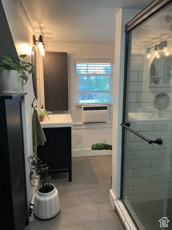 Bathroom with a shower stall, cooling unit, vanity, and wood finished floors